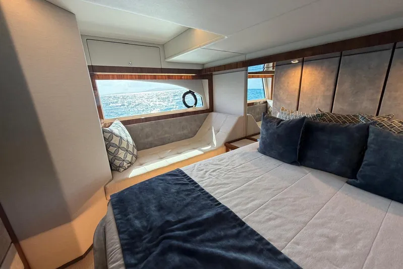 Yacht Photos Pics Luxurious bedroom interior of 2021 Riviera 50 Sports Motor Yacht with ocean view.