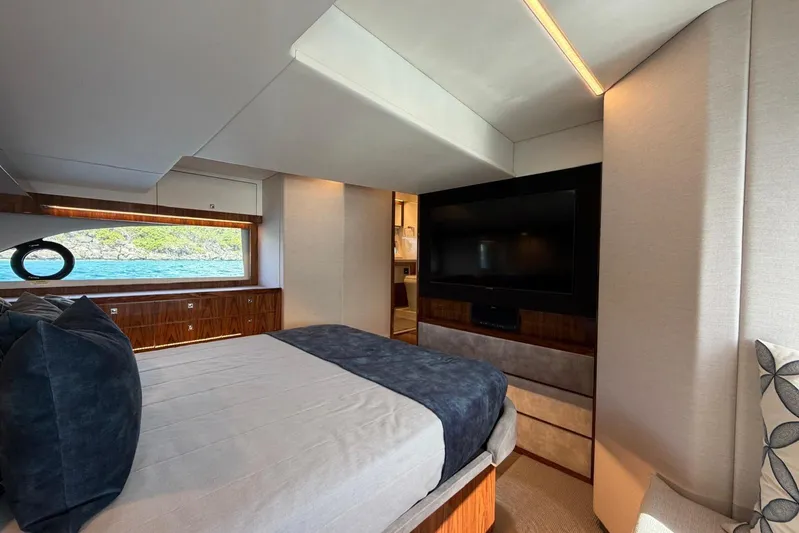 Yacht Photos Pics Luxurious bedroom interior of 2021 Riviera 50 Sports Motor Yacht with scenic window view.