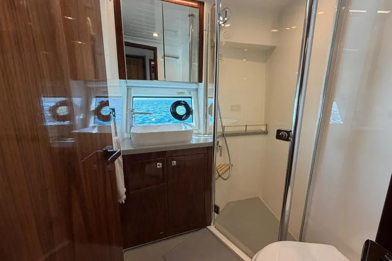  Yacht Photos Pics Luxurious bathroom in 2021 Riviera 50 Sports Motor Yacht with ocean view.