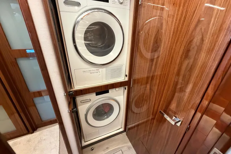  Yacht Photos Pics Laundry area in 2021 Riviera 50 Sports Motor Yacht with stacked washer and dryer.