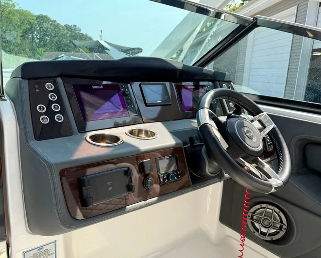  Yacht Photos Pics 2023 Chaparral 280 OSX boat dashboard with steering wheel and navigation screens.