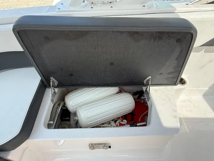  Yacht Photos Pics Open storage compartment on 2023 Chaparral 280 OSX boat with fenders and ropes inside.