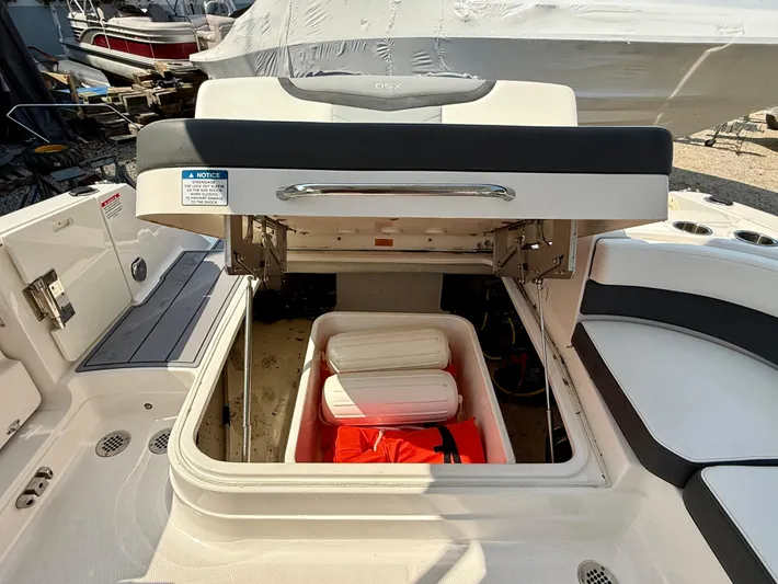  Yacht Photos Pics 2023 Chaparral 280 OSX boat storage compartment with safety equipment and seating area.
