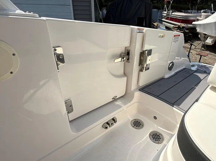  Yacht Photos Pics 2023 Chaparral 280 OSX boat deck with storage compartments and drainage system.