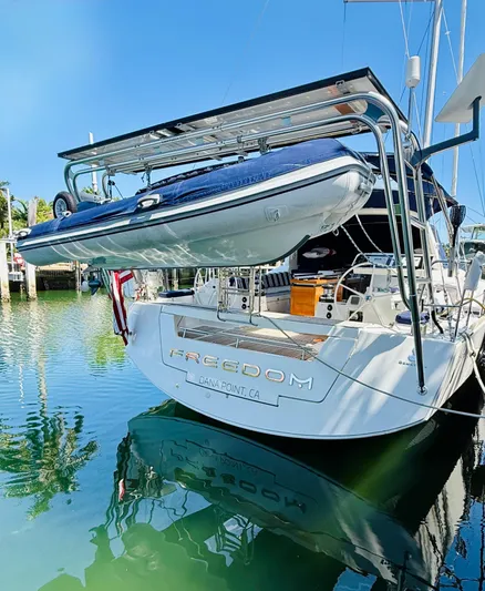 Freedom Yacht Photos Pics Beneteau Oceanis 55 yacht, 2015 model, docked with a dinghy on the stern.