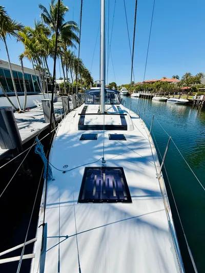 Freedom Yacht Photos Pics 2015 Beneteau Oceanis 55 sailboat docked in a sunny marina.