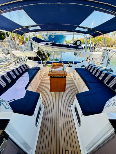 Freedom Yacht Photos Pics 2015 Beneteau Oceanis 55 yacht interior with blue seating and wooden deck.