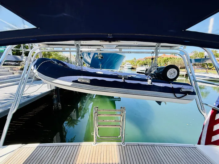 Freedom Yacht Photos Pics Beneteau Oceanis 55 yacht with dinghy, docked in a serene marina, 2015 model.