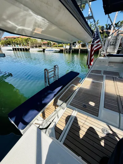 Freedom Yacht Photos Pics Beneteau Oceanis 55 sailboat, 2015 model, docked with teak deck and American flag.