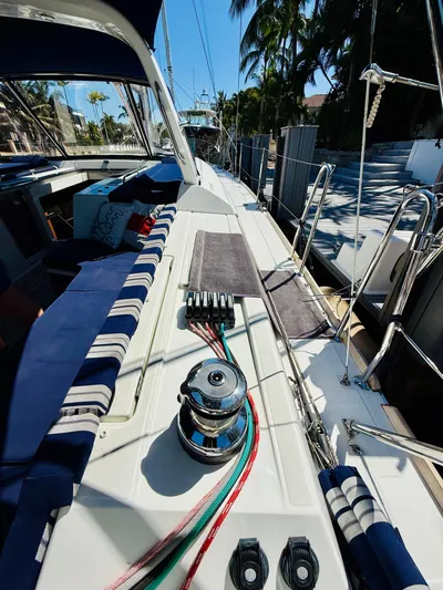 Freedom Yacht Photos Pics 2015 Beneteau Oceanis 55 sailboat deck with winch, ropes, and seating under sunny skies.