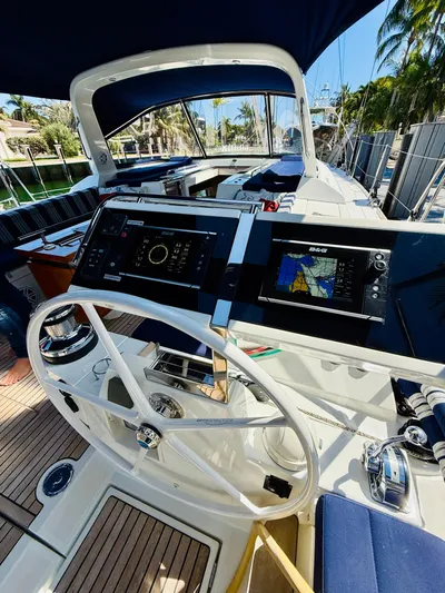 Freedom Yacht Photos Pics 2015 Beneteau Oceanis 55 yacht cockpit with navigation equipment and steering wheel.