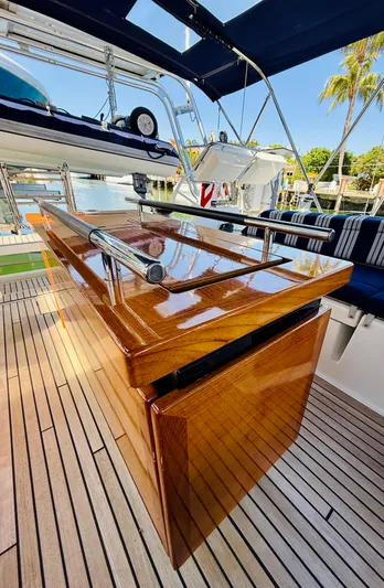 Freedom Yacht Photos Pics Luxurious teak deck and table on 2015 Beneteau Oceanis 55 yacht.