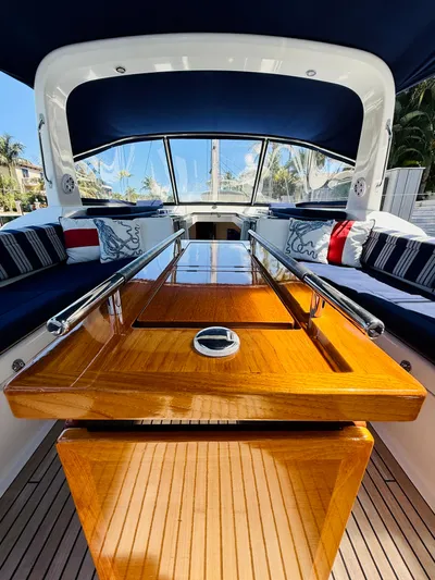 Freedom Yacht Photos Pics Luxurious 2015 Beneteau Oceanis 55 yacht interior with polished wood table and cushioned seating.