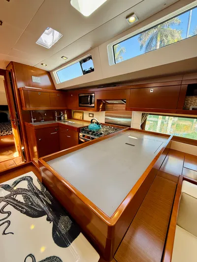 Freedom Yacht Photos Pics Interior of 2015 Beneteau Oceanis 55 yacht with modern kitchen and wooden finishes.