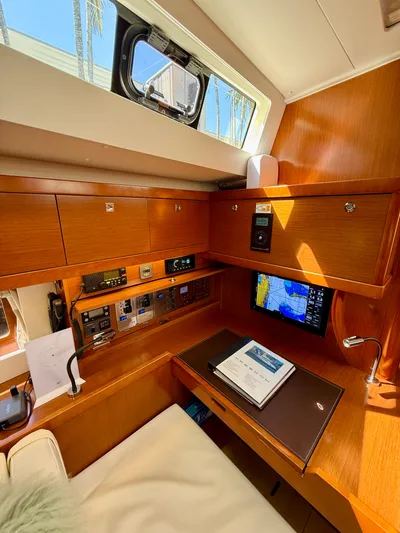 Freedom Yacht Photos Pics Interior of 2015 Beneteau Oceanis 55 yacht with navigation station and wooden cabinetry.