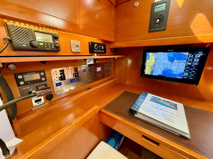 Freedom Yacht Photos Pics Navigation station of 2015 Beneteau Oceanis 55 yacht with electronic equipment and chart display.