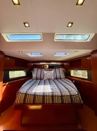 Freedom Yacht Photos Pics Luxurious cabin interior of 2015 Beneteau Oceanis 55 yacht with skylights and striped bedding.