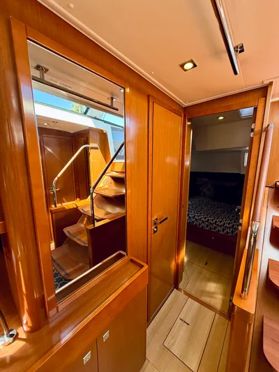 Freedom Yacht Photos Pics Interior of 2015 Beneteau Oceanis 55 yacht, featuring wooden finishes and a cozy cabin.