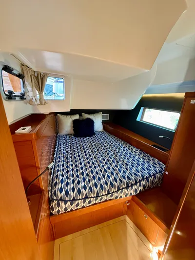 Freedom Yacht Photos Pics Cozy cabin interior of 2015 Beneteau Oceanis 55 sailboat with patterned bedding.