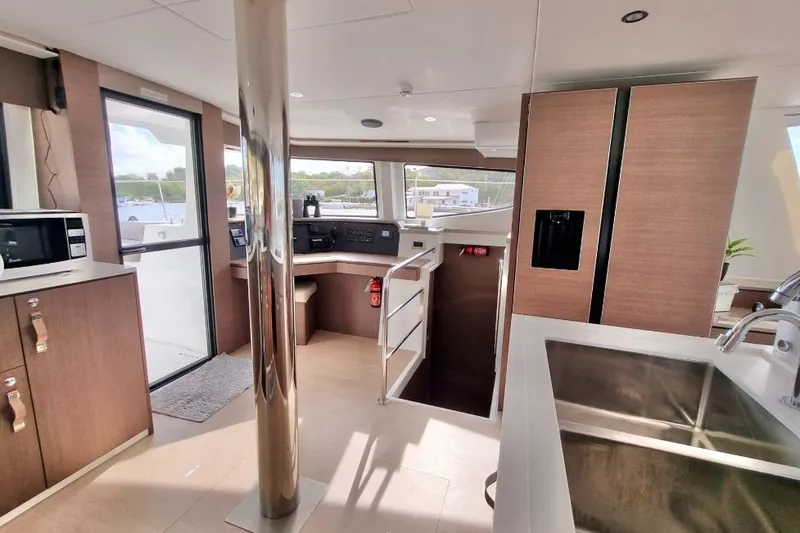 Breezin Yacht Photos Pics Modern interior of 2022 Bali 4.6 yacht with kitchen and navigation area.