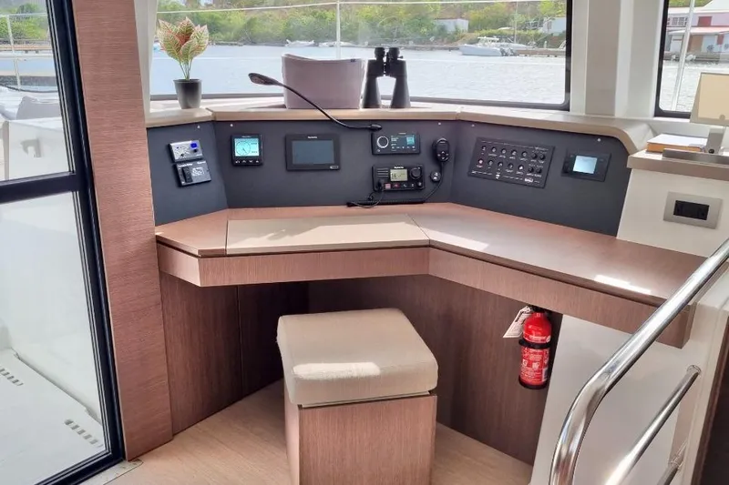 Breezin Yacht Photos Pics Modern helm station on 2022 Bali 4.6 yacht with navigation equipment and fire extinguisher.