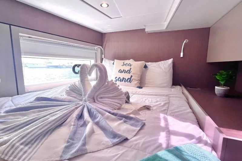 Breezin Yacht Photos Pics Luxurious Bali 4.6 yacht bedroom with swan towel art and "Sea and Sand" pillow.