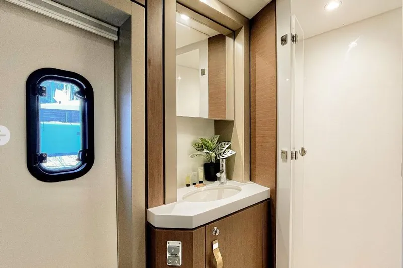 Breezin Yacht Photos Pics Luxurious bathroom interior of 2022 Bali 4.6 yacht with modern fixtures and porthole window.