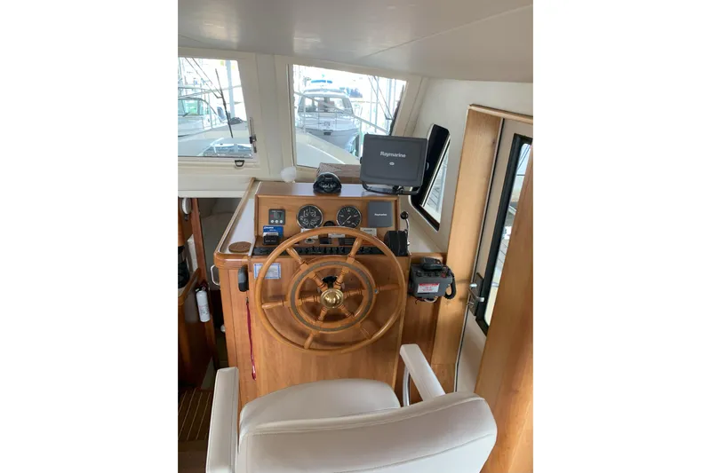 Nite Owl Yacht Photos Pics helm with wooden wheel and navigation equipment