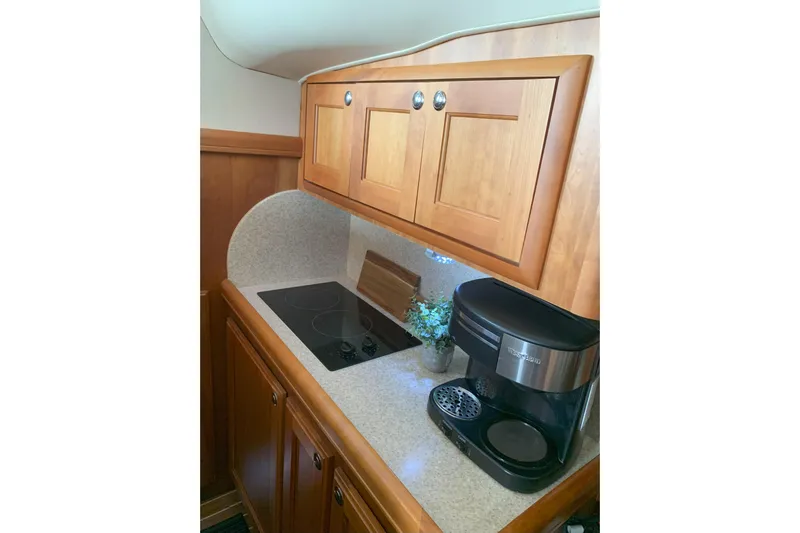 Nite Owl Yacht Photos Pics stove, coffee maker, and wooden cabinets