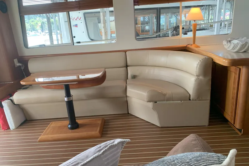 Nite Owl Yacht Photos Pics luxurious interior with leather seating and wooden table.