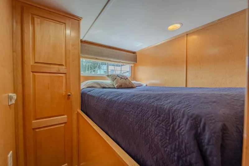 Southern Belle Yacht Photos Pics Cozy bedroom interior of 2014 Sunstar Houseboats 55, featuring wood paneling and a comfortable bed.