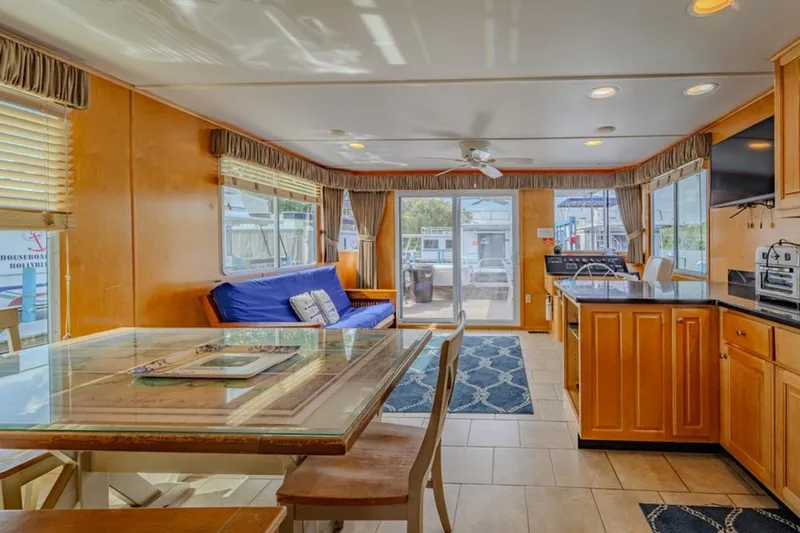 Southern Belle Yacht Photos Pics Interior of 2014 Sunstar Houseboats 55, featuring kitchen, dining area, and large windows.