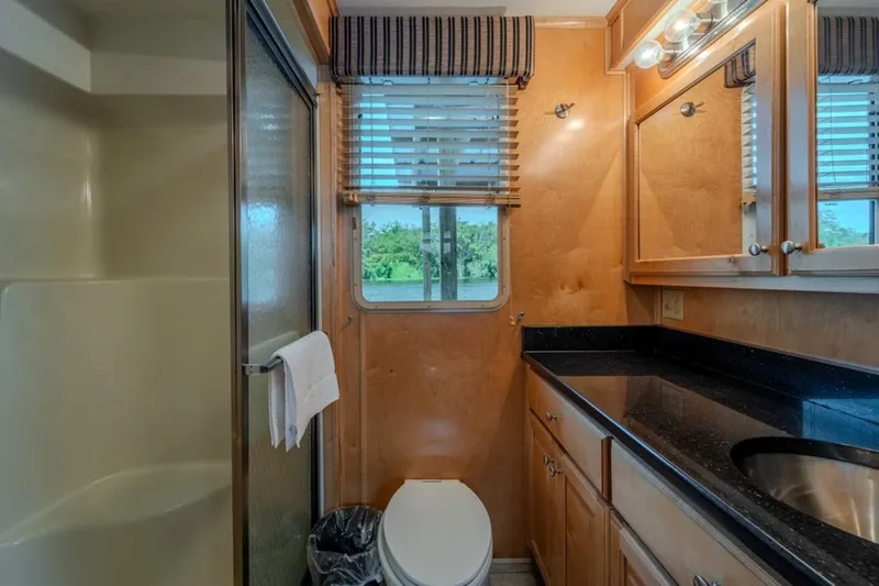 Southern Belle Yacht Photos Pics Bathroom interior of 2014 Sunstar Houseboats 55, featuring shower, sink, and window view.