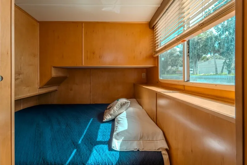 Southern Belle Yacht Photos Pics Cozy bedroom in 2014 Sunstar Houseboats 55, featuring wood paneling and large window.