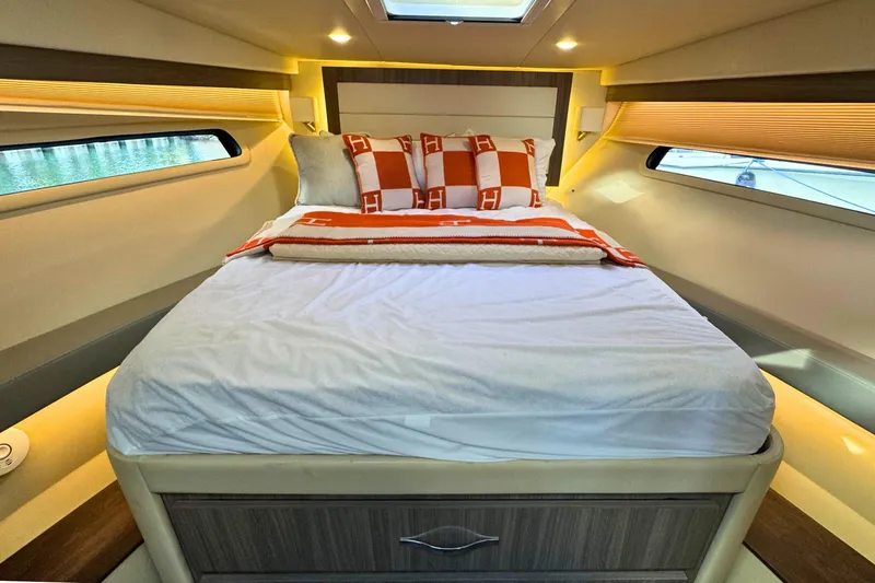  Yacht Photos Pics Luxurious bedroom interior of 2021 Regal 38 Grande Coupe yacht with elegant bedding.
