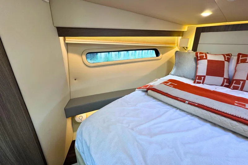  Yacht Photos Pics Interior of 2021 Regal 38 Grande Coupe, featuring a cozy bedroom with elegant bedding.