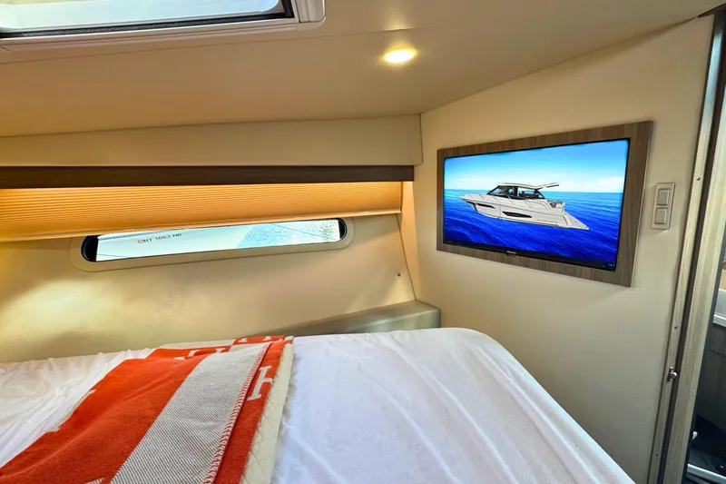  Yacht Photos Pics Interior of 2021 Regal 38 Grande Coupe with bed and wall-mounted TV.