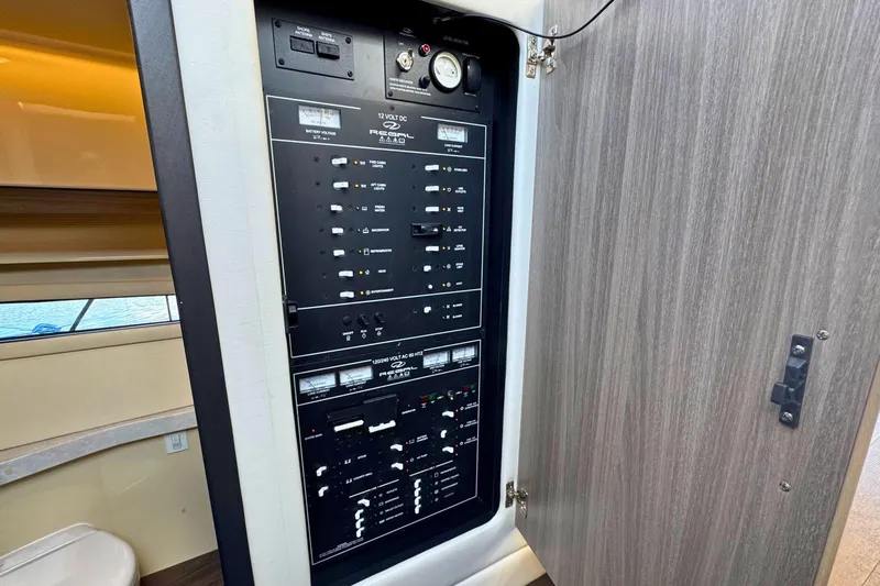  Yacht Photos Pics Electrical panel inside 2021 Regal 38 Grande Coupe yacht, showcasing control switches and gauges.