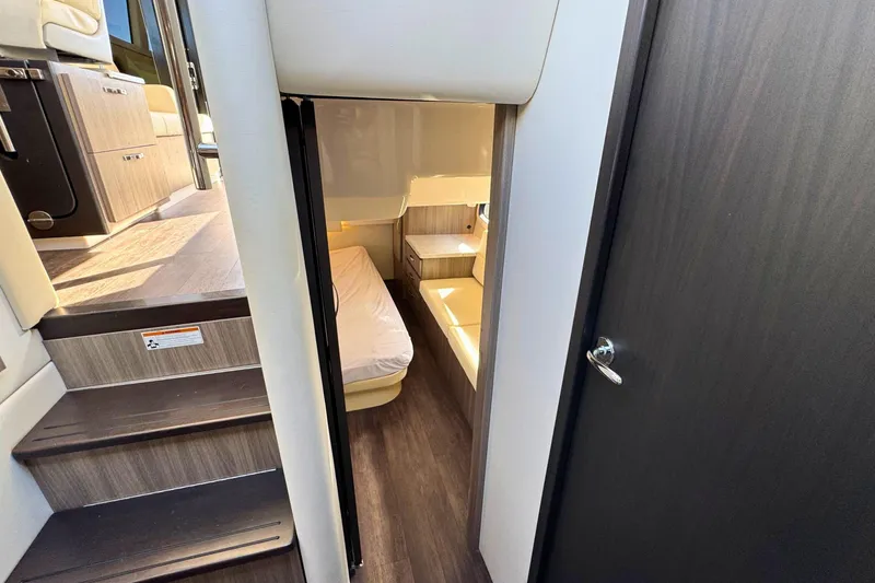  Yacht Photos Pics 2021 Regal 38 Grande Coupe interior cabin with stairs and cozy sleeping area.