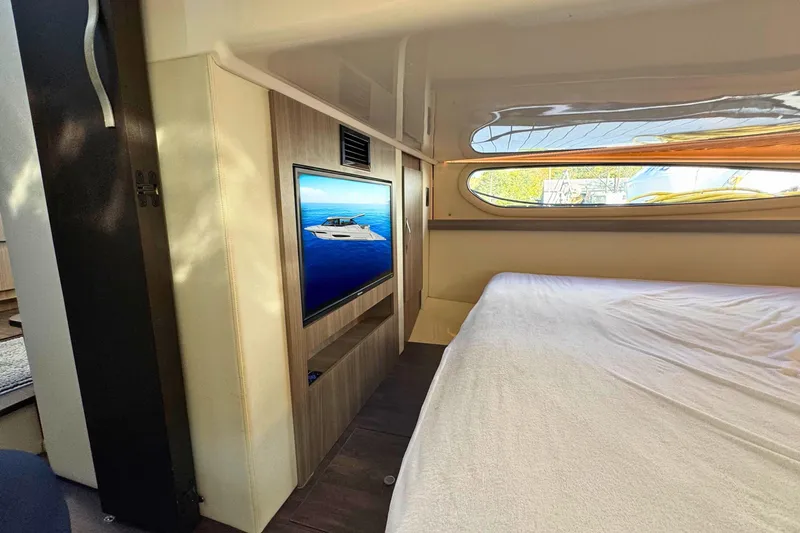  Yacht Photos Pics Interior of 2021 Regal 38 Grande Coupe with bed and wall-mounted TV.