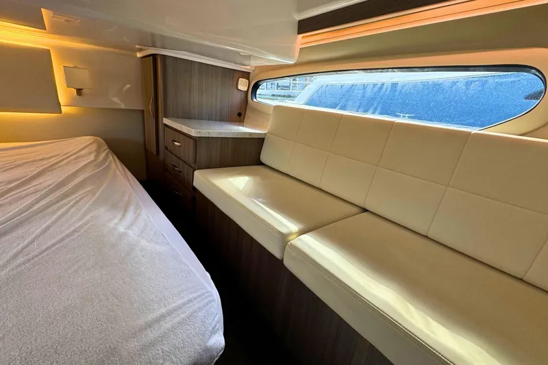  Yacht Photos Pics Interior of 2021 Regal 38 Grande Coupe with bed, sofa, and window view.