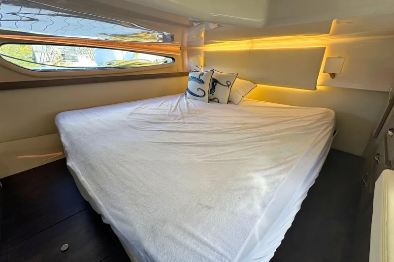  Yacht Photos Pics Luxurious cabin interior of 2021 Regal 38 Grande Coupe yacht with cozy bedding.