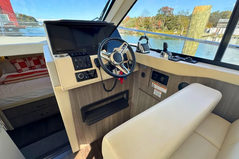  Yacht Photos Pics 2021 Regal 38 Grande Coupe helm with modern controls and comfortable seating.