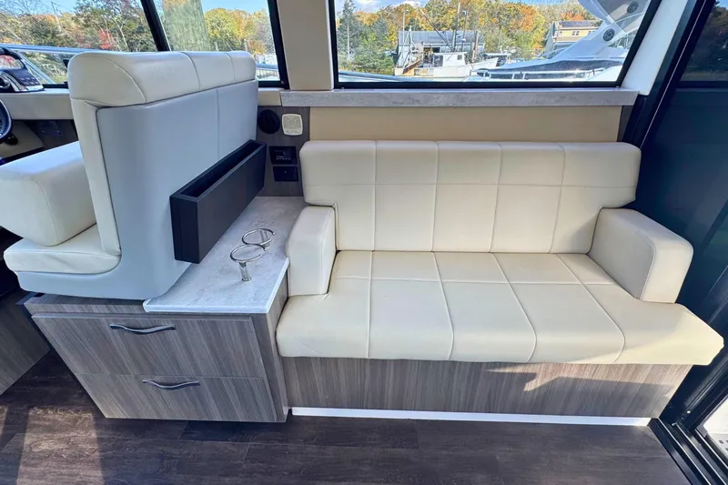  Yacht Photos Pics Interior of 2021 Regal 38 Grande Coupe with beige seating and wood accents.