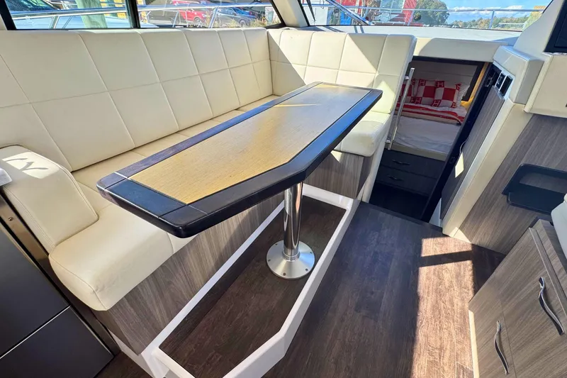  Yacht Photos Pics Interior of 2021 Regal 38 Grande Coupe with elegant seating and table setup.