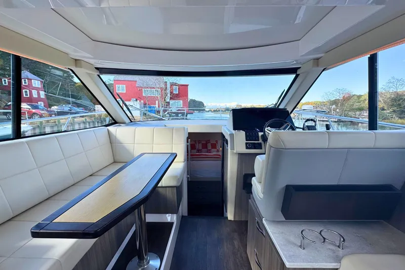  Yacht Photos Pics Interior of 2021 Regal 38 Grande Coupe yacht with luxurious seating and helm.