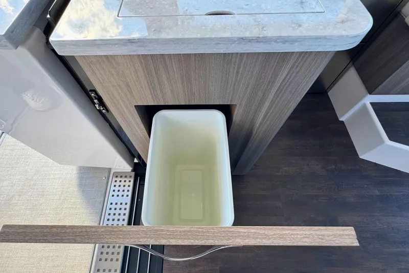  Yacht Photos Pics 2021 Regal 38 Grande Coupe interior with pull-out trash bin and sleek countertop.