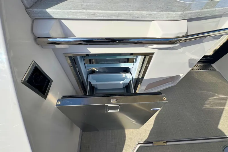  Yacht Photos Pics 2021 Regal 38 Grande Coupe yacht interior with open drawer-style refrigerator.
