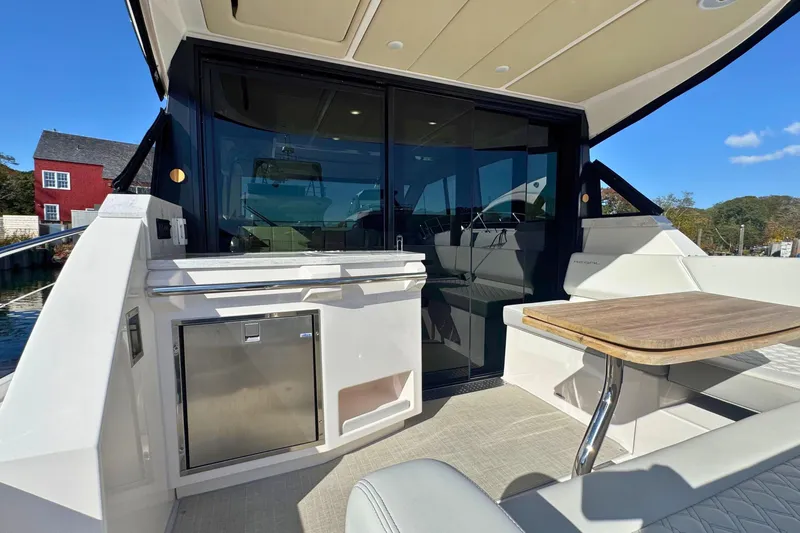  Yacht Photos Pics 2021 Regal 38 Grande Coupe yacht interior with seating and table, showcasing luxury design.