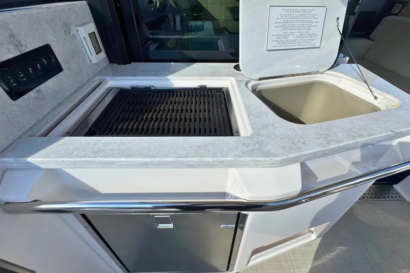  Yacht Photos Pics Outdoor kitchen on 2021 Regal 38 Grande Coupe yacht with grill and sink.